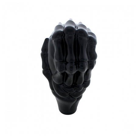 Close-up of black skull and hand gearshift knob
